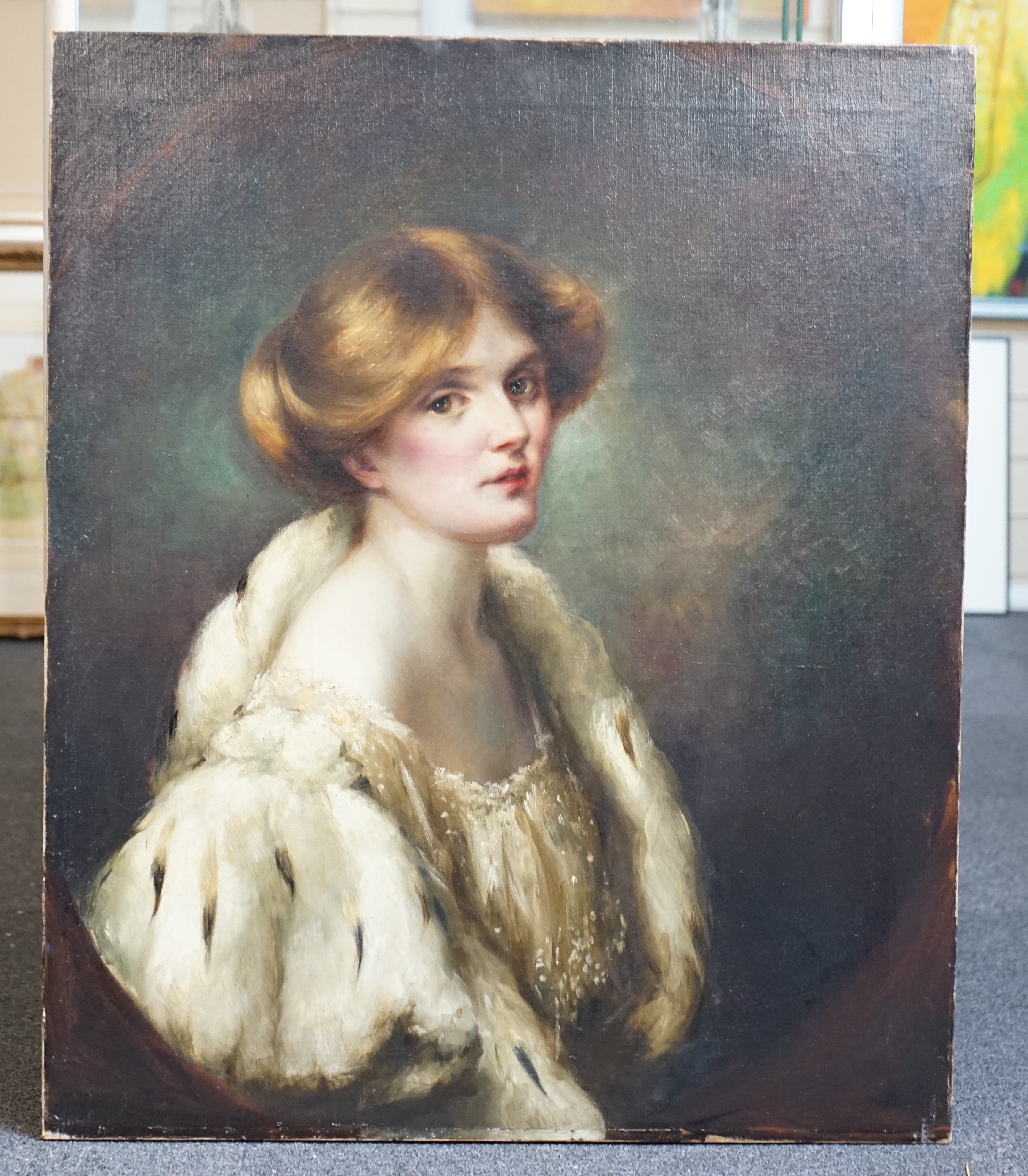 English School c.1900, oil on canvas, Portrait of a young lady wearing an ermine trimmed cape, painted to the oval, 77 x 64cm, unframed